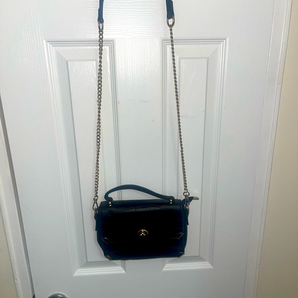Small black bag with golden metal strap